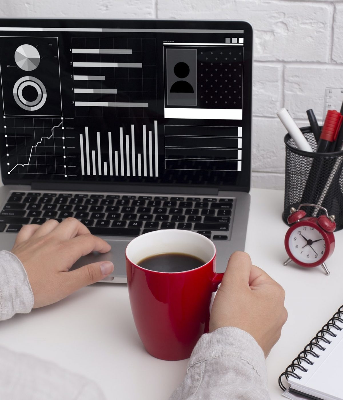 Female financial analyst working on laptop at office, studying statistics graphs